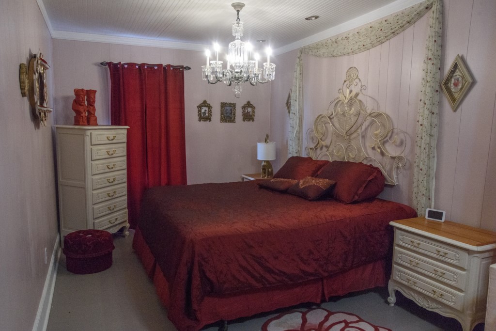A King Size Bed With a Maroon Color Bed Cover